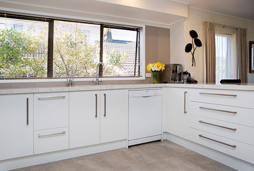 Cabinetry in the shade of Alabaster, the Silestone bench in Blanco Orion and tiles in a muted grey