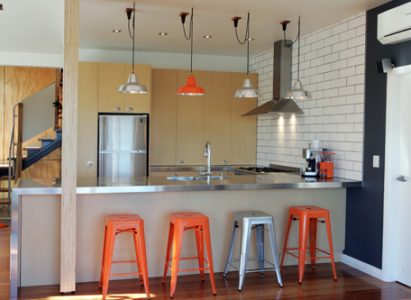 Timber cabinets with stainless steel benchtop by Jag Kitchens